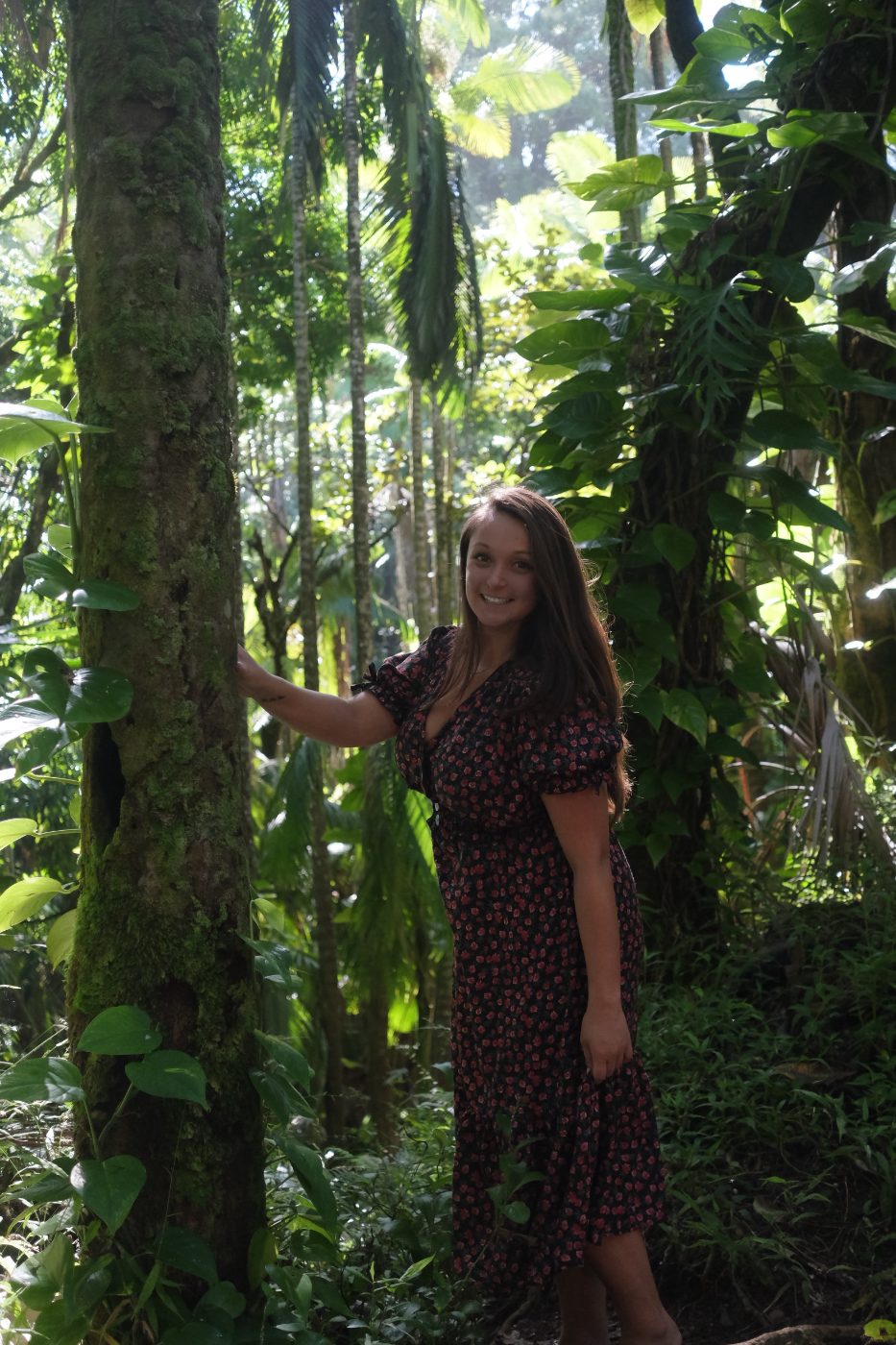Emily Powers smiling in a lush Hawaiian jungle