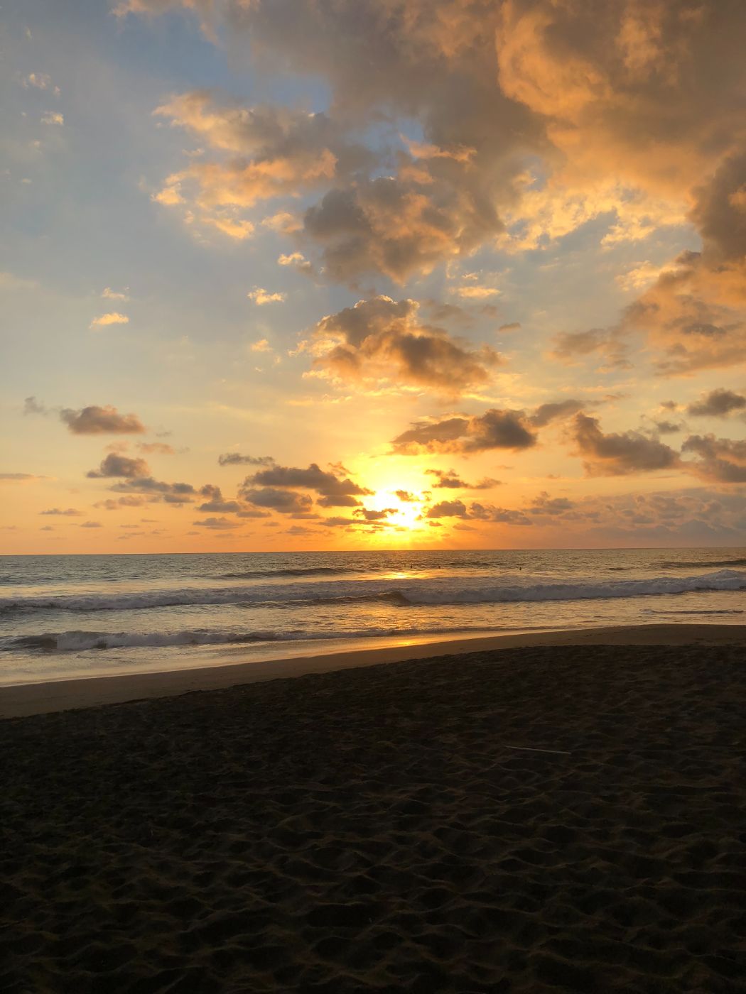 A golden sunset over the ocean and shoreline