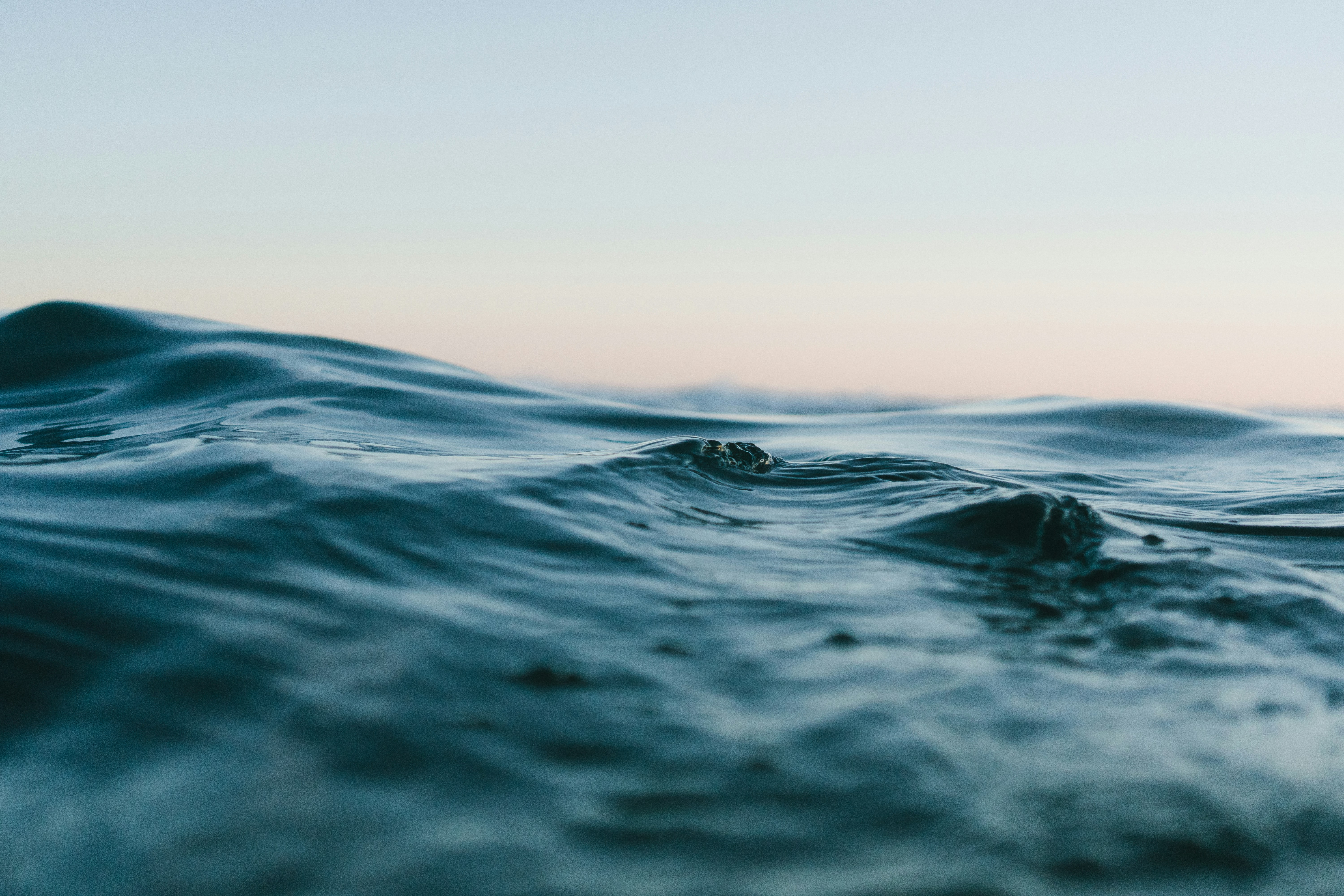 An ocean wave at dusk